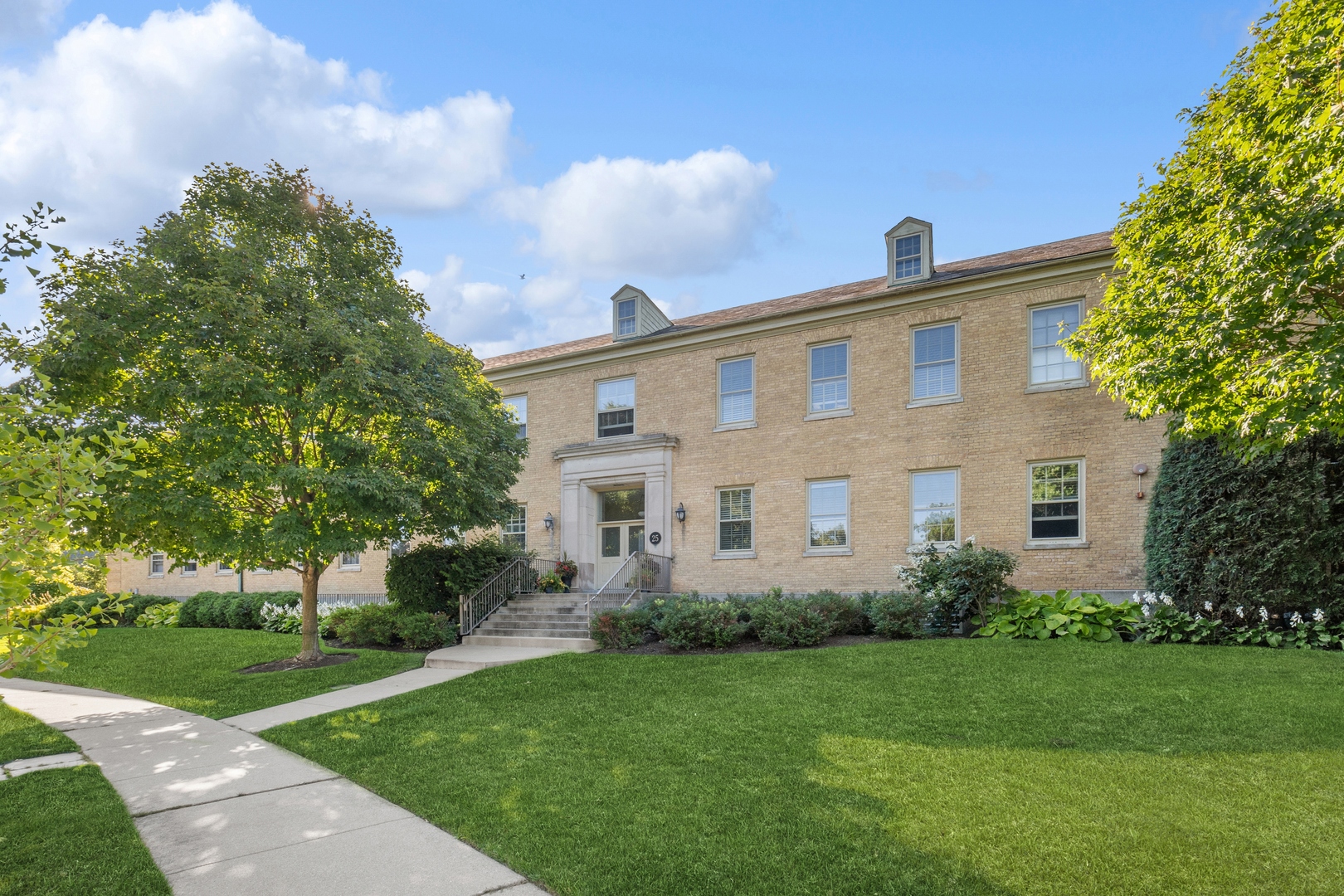 25 Ronan Road, Unit 106 Highwood, IL 60040 - Photo 1 of 14 a front view of house with yard and green space
