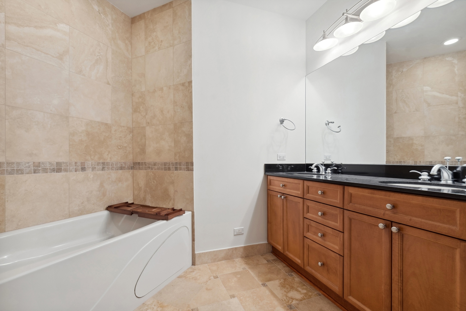 25 Ronan Road, Unit 106 Highwood, IL 60040 - Photo 10 of 14 a bathroom with a granite countertop sink and a bathtub