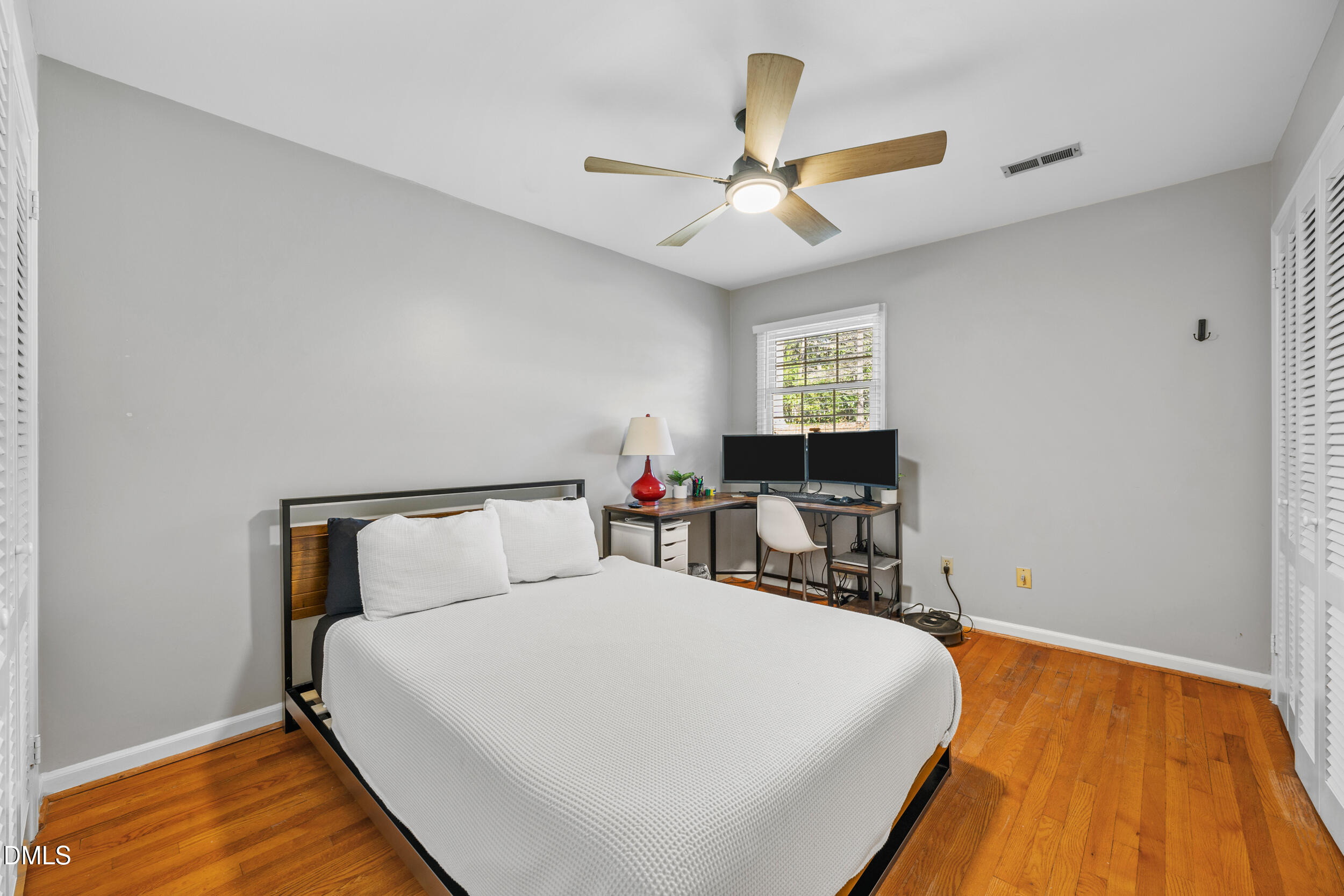 3726 Swift Drive Raleigh, NC 27606 - Photo 24 of 40 a bed room with a bed and a chandelier