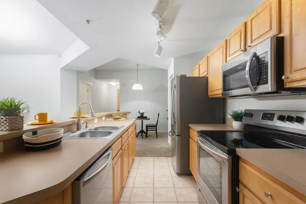 a kitchen with stainless steel appliances a sink a stove and a refrigerator
