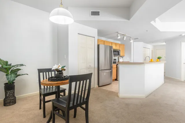a kitchen with refrigerator a microwave and cabinets