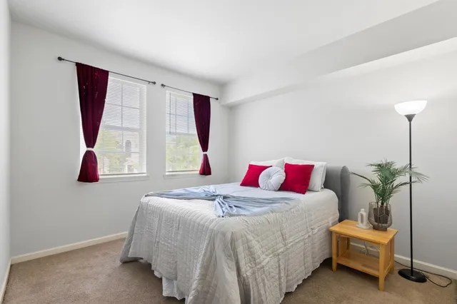 a bed sitting in a bedroom next to a window