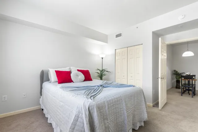 a bedroom with a bed and a table