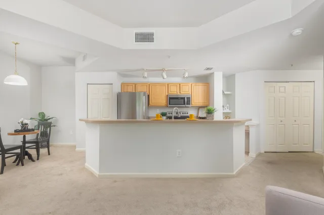a living room with kitchen island furniture and a window