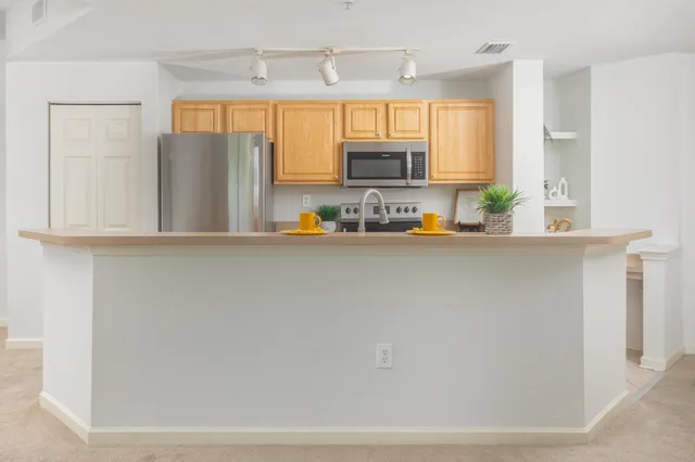 a kitchen with a sink a refrigerator and a window