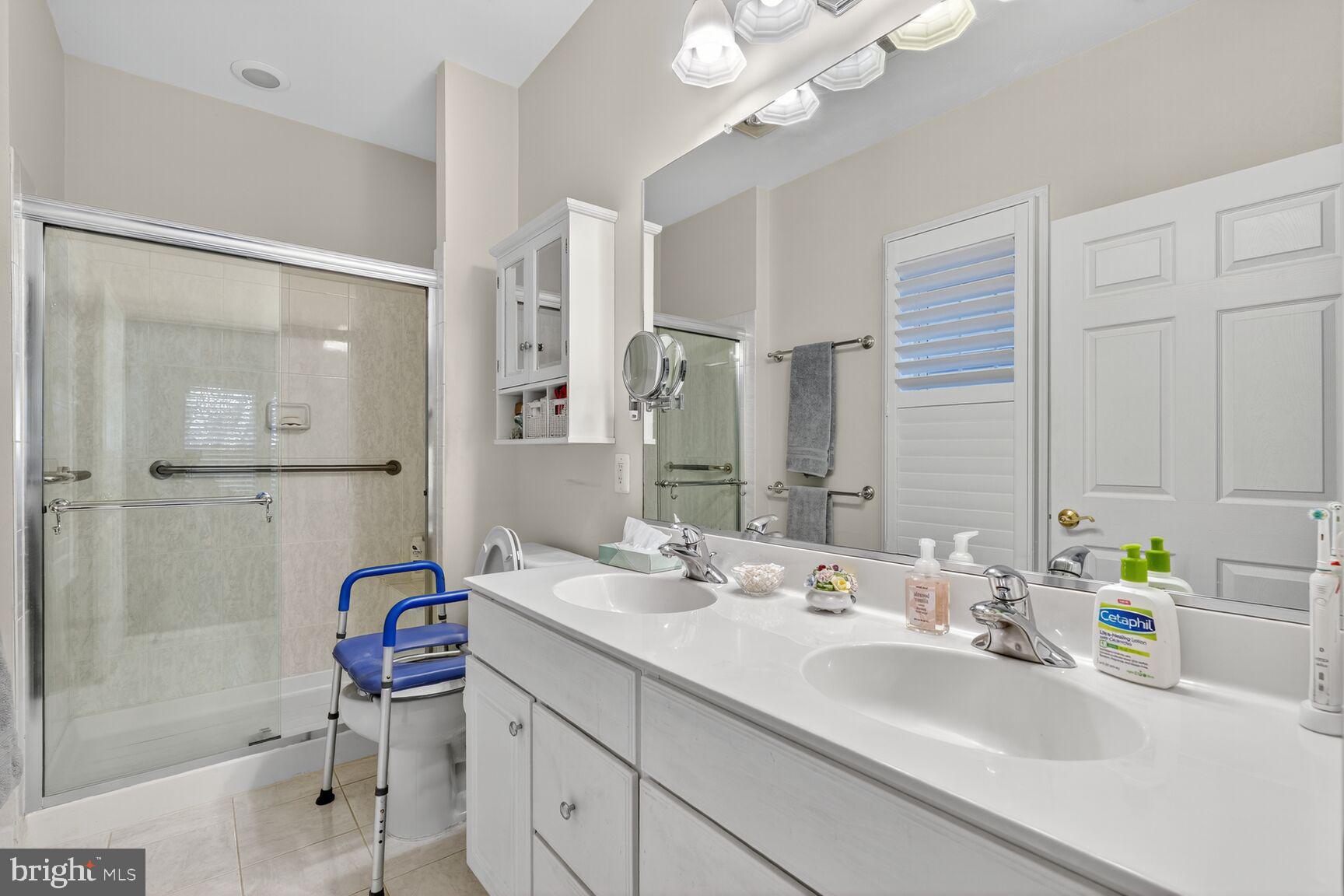 8912 Yellow Daisy Place Lorton, VA 22079 - Photo 12 of 24 a bathroom with a double vanity sink mirror and shower