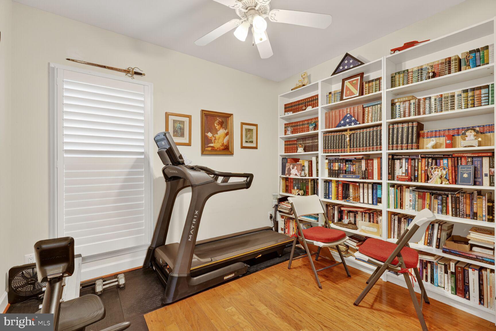 8912 Yellow Daisy Place Lorton, VA 22079 - Photo 20 of 24 a bedroom with furniture and a book shelf