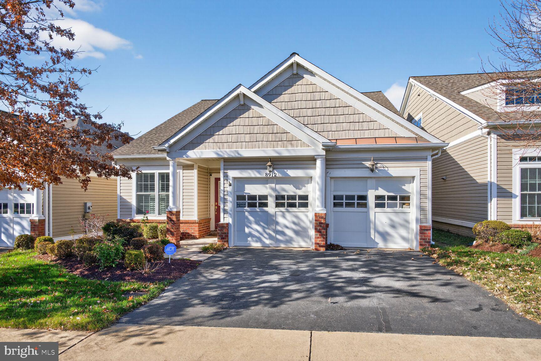 8912 Yellow Daisy Place Lorton, VA 22079 - Photo 24 of 24 a front view of a house with garden