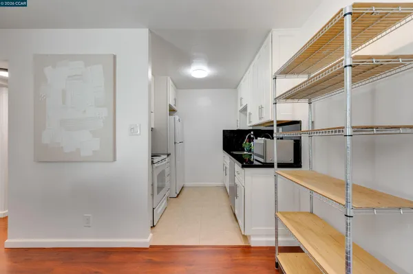 a kitchen with stainless steel appliances a stove refrigerator sink and microwave