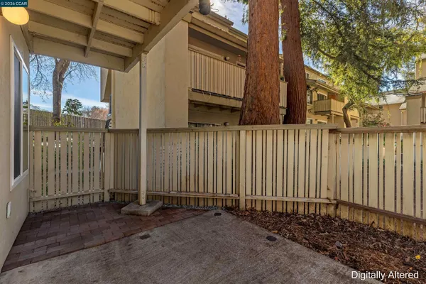 a view of a house with wooden fence