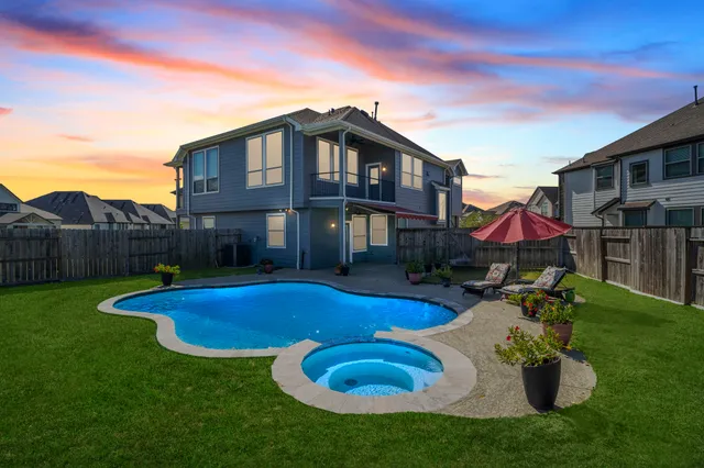 a view of a house with swimming pool and porch