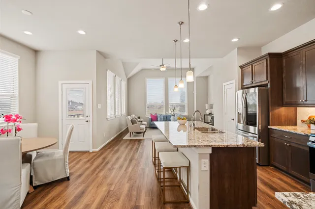 a kitchen with sink cabinets and wooden floor
