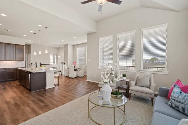 a living room with furniture and kitchen view