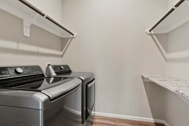 a view of walk in closet with empty racks