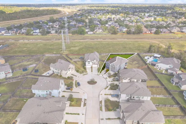 an aerial view of a house with a lake view