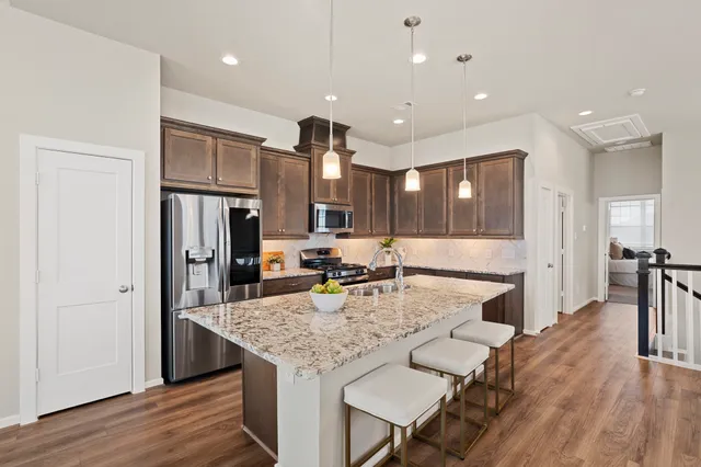 a view of a hallway with wooden floor and furniture