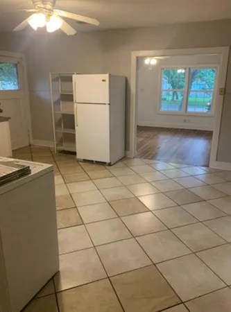 a view of a livingroom with furniture and a window