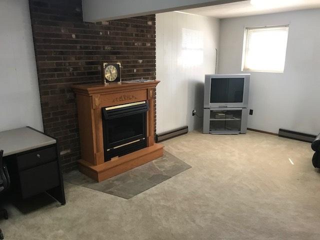1956 Burma Road Salem, VA 24153 - Photo 14 of 25 a living room with furniture a flat screen tv and a fireplace