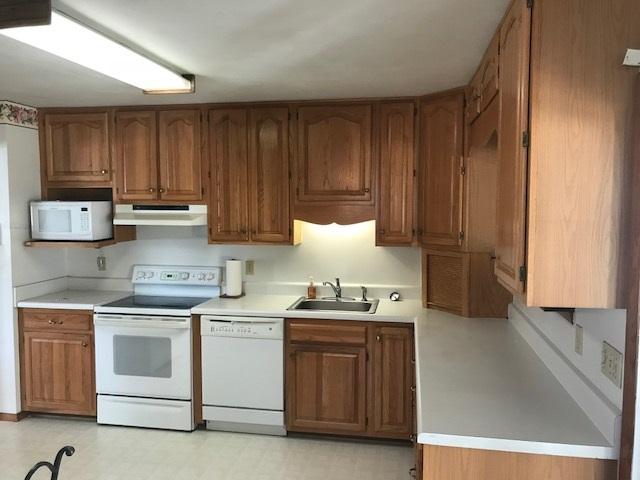 1956 Burma Road Salem, VA 24153 - Photo 5 of 25 a kitchen with stainless steel appliances granite countertop a stove a sink and a microwave