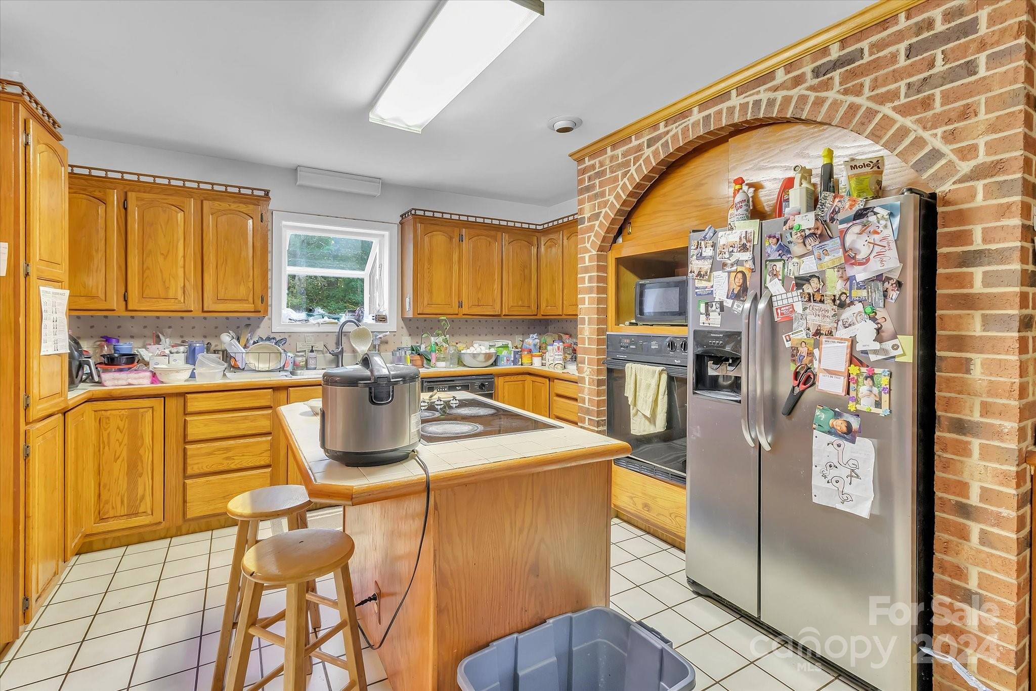 2131 Pinebrook Circle Charlotte, NC 28208 - Photo 15 of 23 a kitchen with stainless steel appliances granite countertop a sink a stove and refrigerator