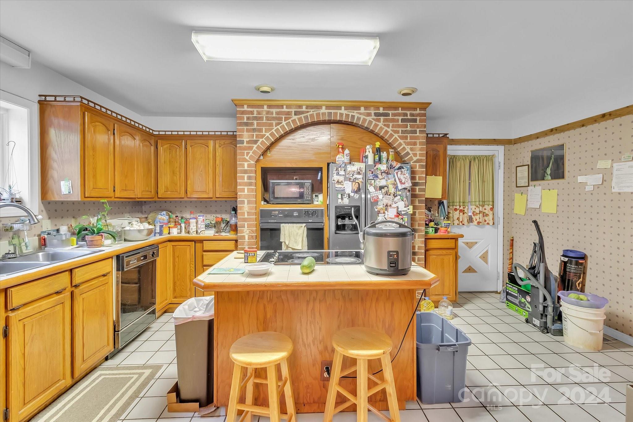2131 Pinebrook Circle Charlotte, NC 28208 - Photo 16 of 23 a view of a kitchen with kitchen island granite countertop a sink cabinets and window