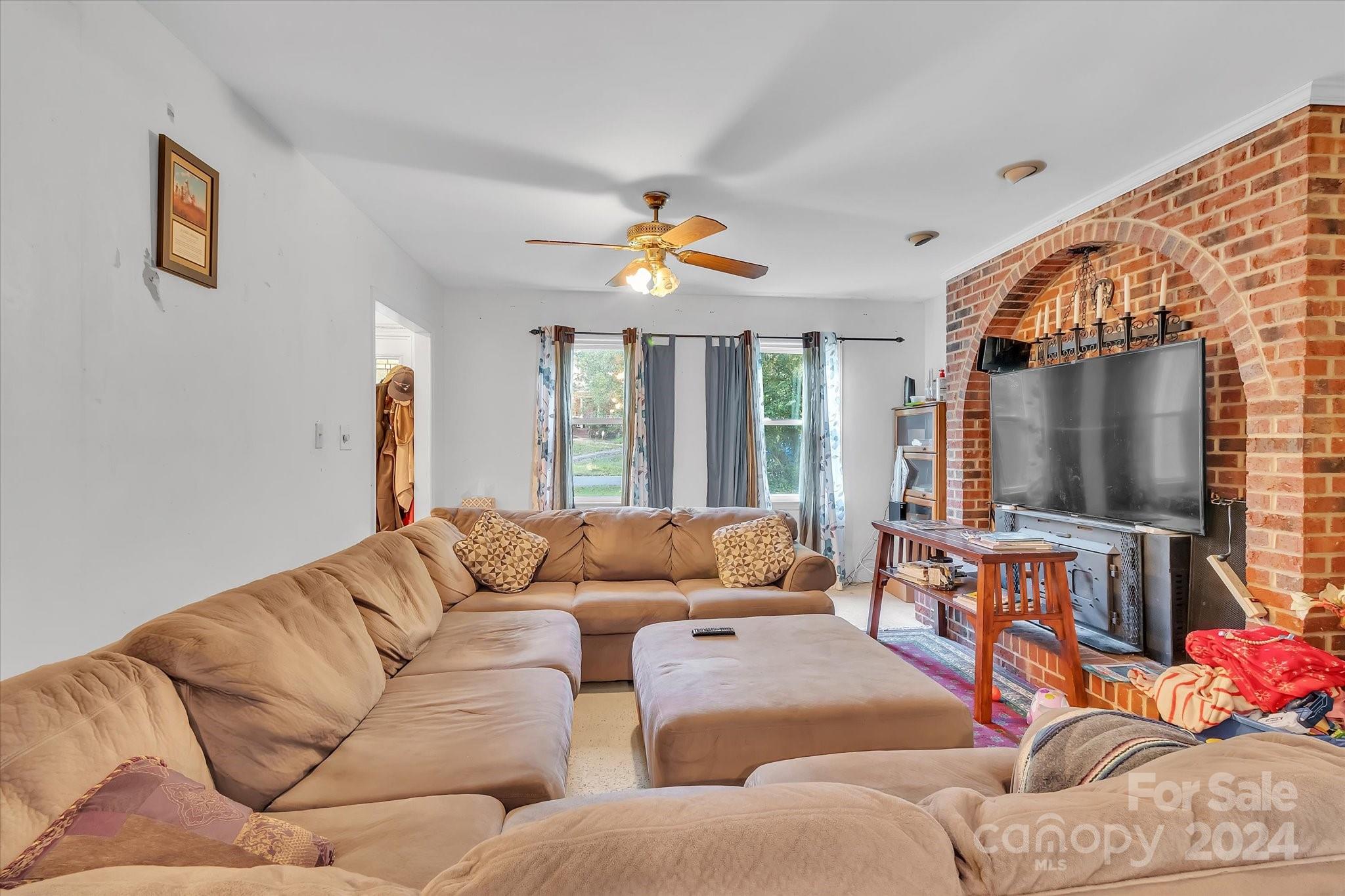 2131 Pinebrook Circle Charlotte, NC 28208 - Photo 19 of 23 a living room with furniture fireplace and a flat screen tv