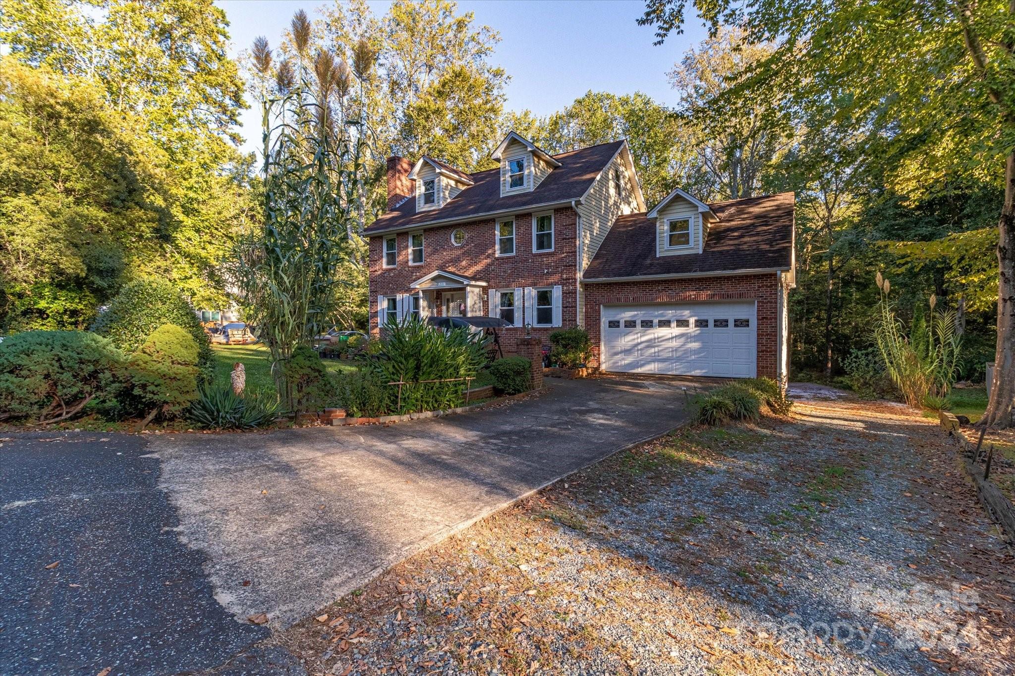 2131 Pinebrook Circle Charlotte, NC 28208 - Photo 3 of 23 a front view of a house with a yard and a garage