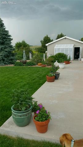 3380 Corral Ranch Road Peyton, CO 80831 - Photo 4 of 25 Side yard with Greenhouse attached to the garage
