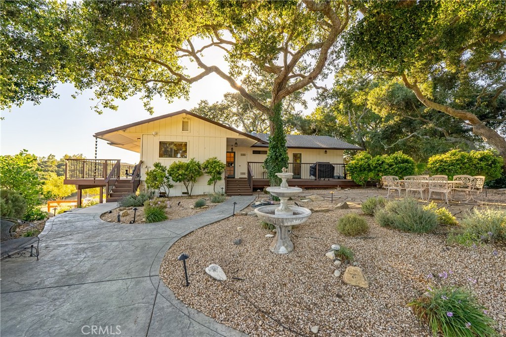 115 Booker Road Templeton, CA 93465 - Photo 23 of 76 a backyard of a house with table and chairs under an umbrella