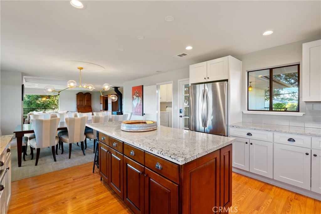 115 Booker Road Templeton, CA 93465 - Photo 37 of 76 a large kitchen with stainless steel appliances a stove center island a table and chairs