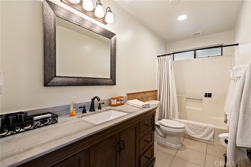 115 Booker Road Templeton, CA 93465 - Photo 43 of 76 a bathroom with a double vanity sink toilet mirror and shower