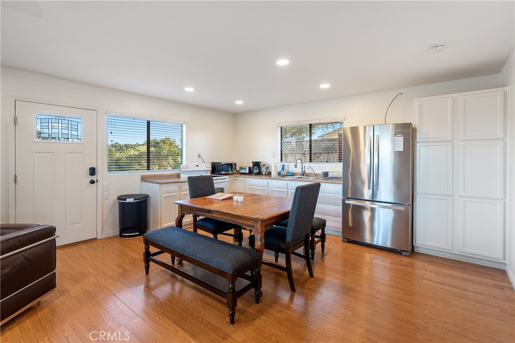 115 Booker Road Templeton, CA 93465 - Photo 55 of 76 a living room with furniture a refrigerator and a dining table with wooden floor
