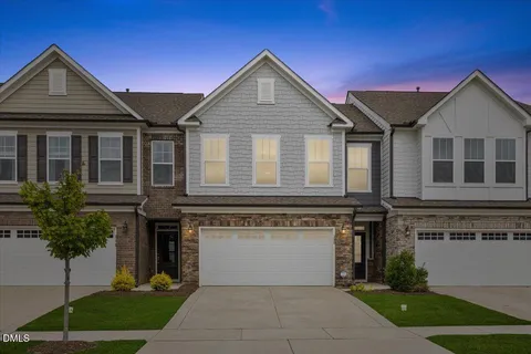 a front view of a house with a garden and plants