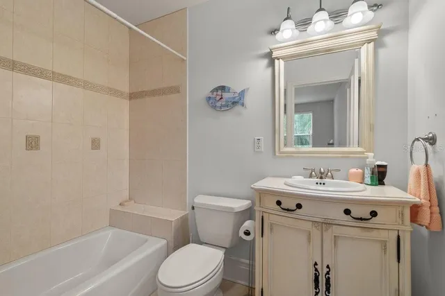 a backyard of a house with table and chairs plants and palm trees