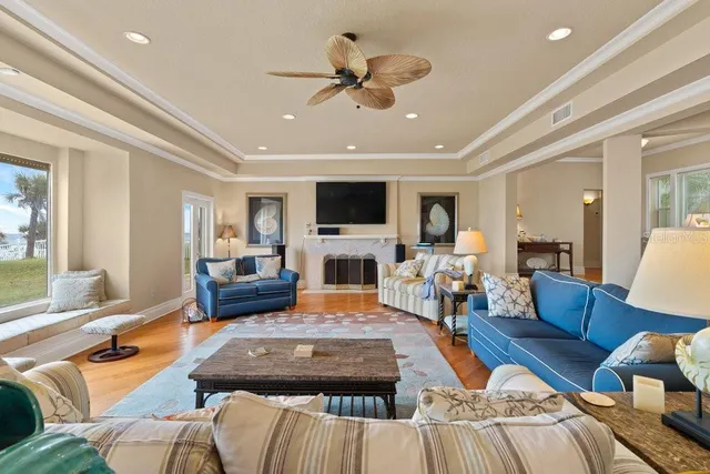 a kitchen with stainless steel appliances granite countertop a kitchen island a stove a refrigerator a sink a dining table and chairs