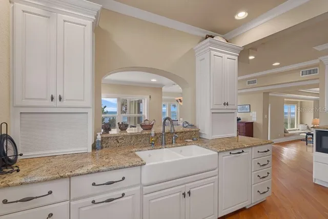 a living room with furniture windows and a chandelier