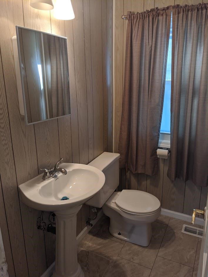 4769 Pelley Road Rockford, IL 61102 - Photo 11 of 33 a bathroom with a sink a toilet and mirror