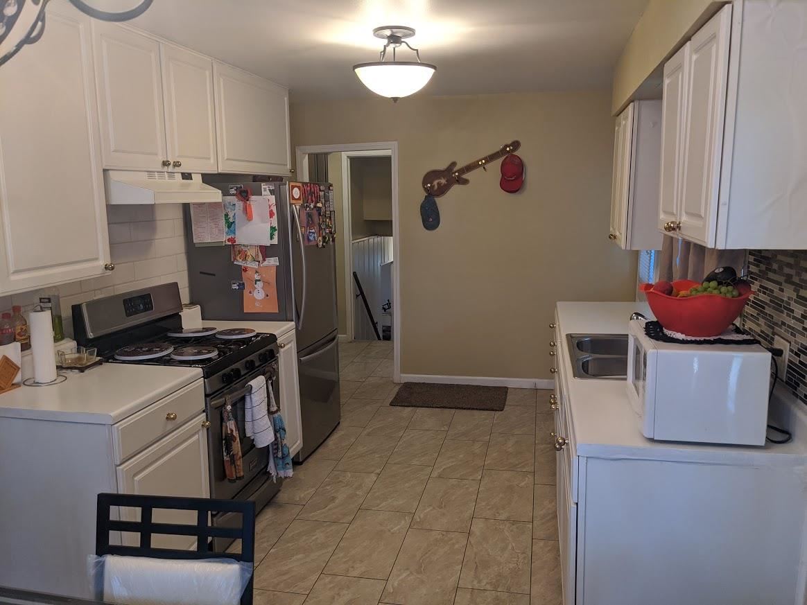 4769 Pelley Road Rockford, IL 61102 - Photo 8 of 33 a kitchen with stainless steel appliances granite countertop a stove and a refrigerator