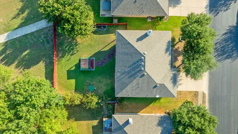 an aerial view of a house with a yard