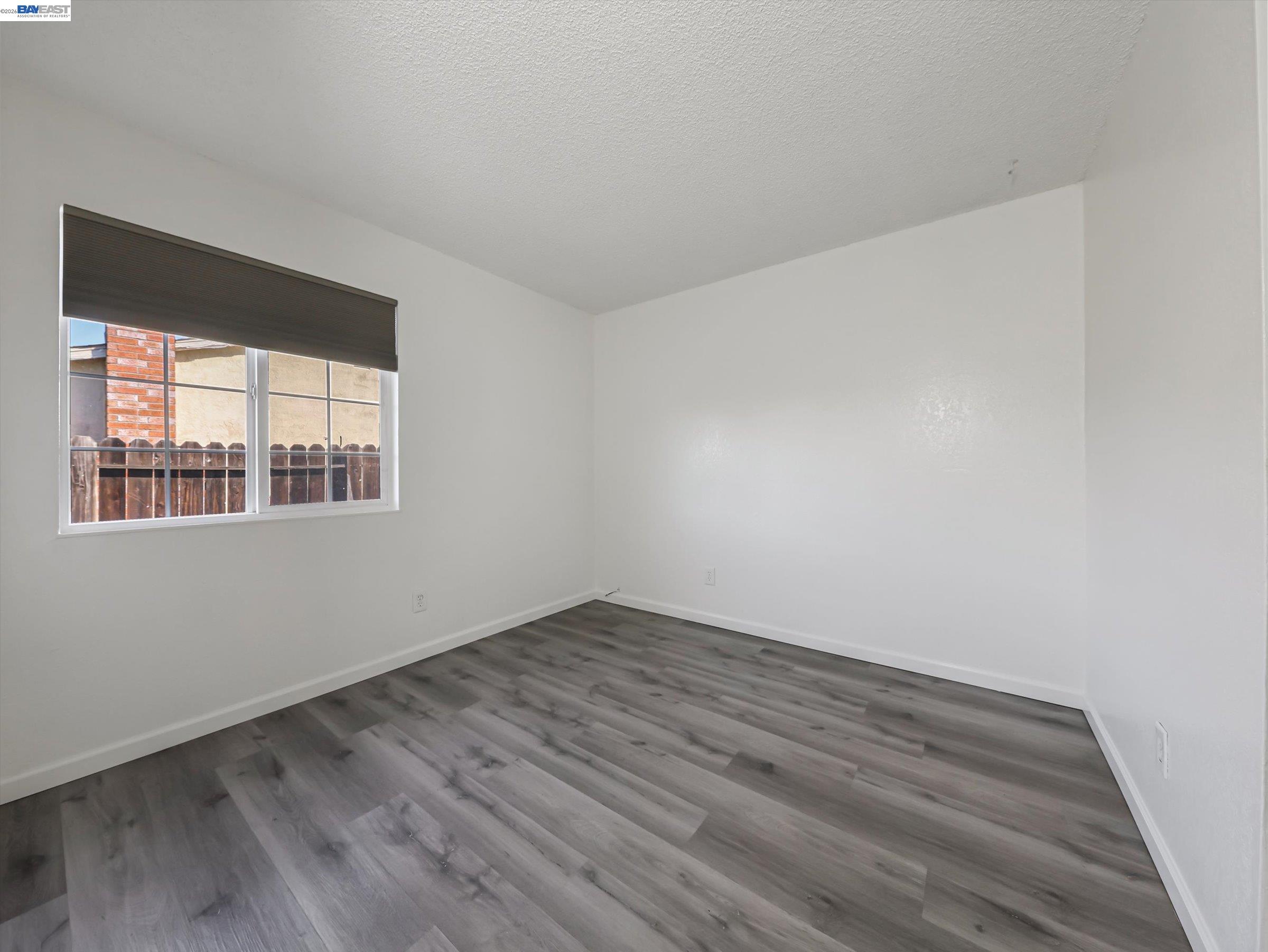 3432 Danielle Place Bay Point, CA 94565 - Photo 27 of 36 a view of an empty room with wooden floor and a window