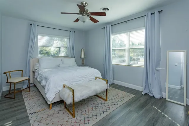 a bedroom with a bed lamps and window