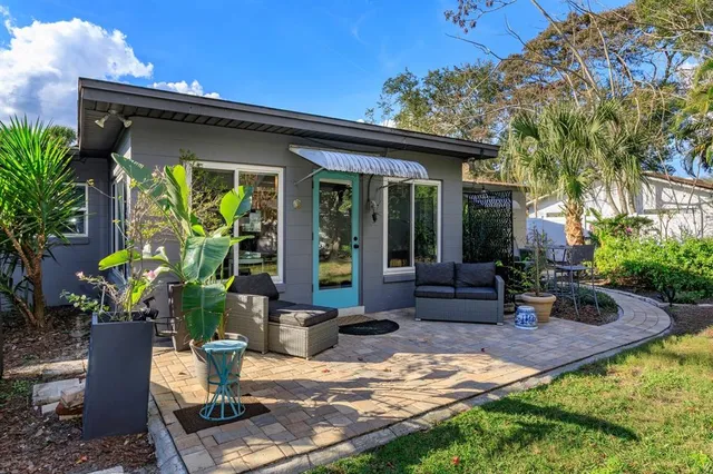 a view of a house with backyard sitting area and porch