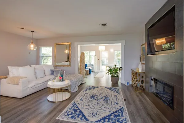 a living room with furniture and wooden floor