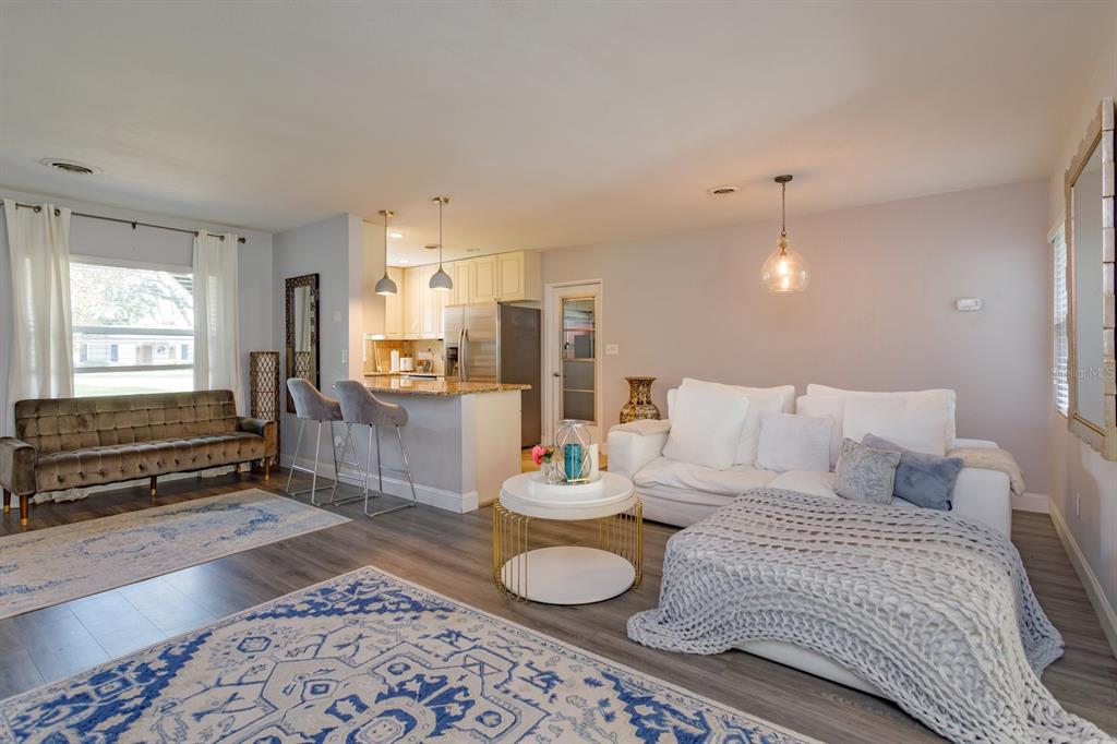 1105 Strathmore Drive Orlando, FL 32806 - Photo 6 of 25 a bedroom with a bed and wooden floor