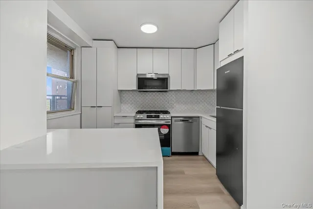 a kitchen with a refrigerator and a stove