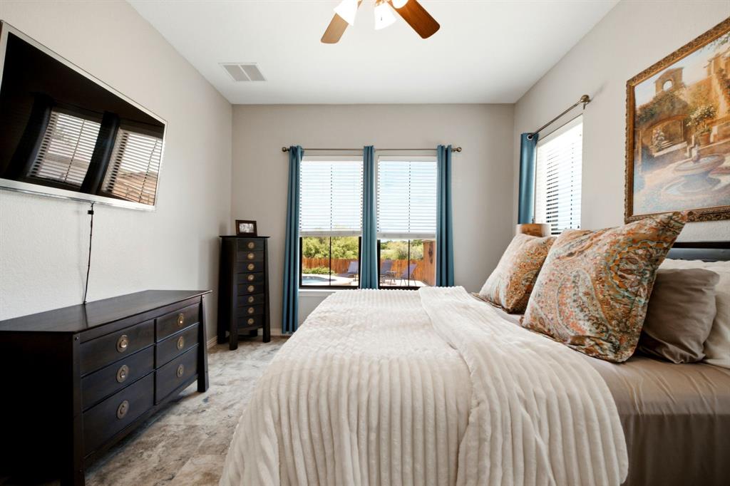 600 Aspen Street Pilot Point, TX 76258 - Photo 10 of 39 Bedroom featuring light-colored walls, wood-finish flooring, and a ceiling fan
