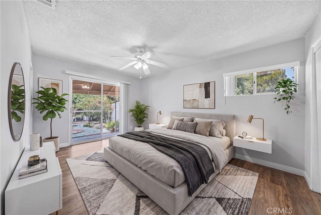 29078 Bradley Road Menifee, CA 92586 - Photo 25 of 42 a bedroom with a bed a couch and a potted plant