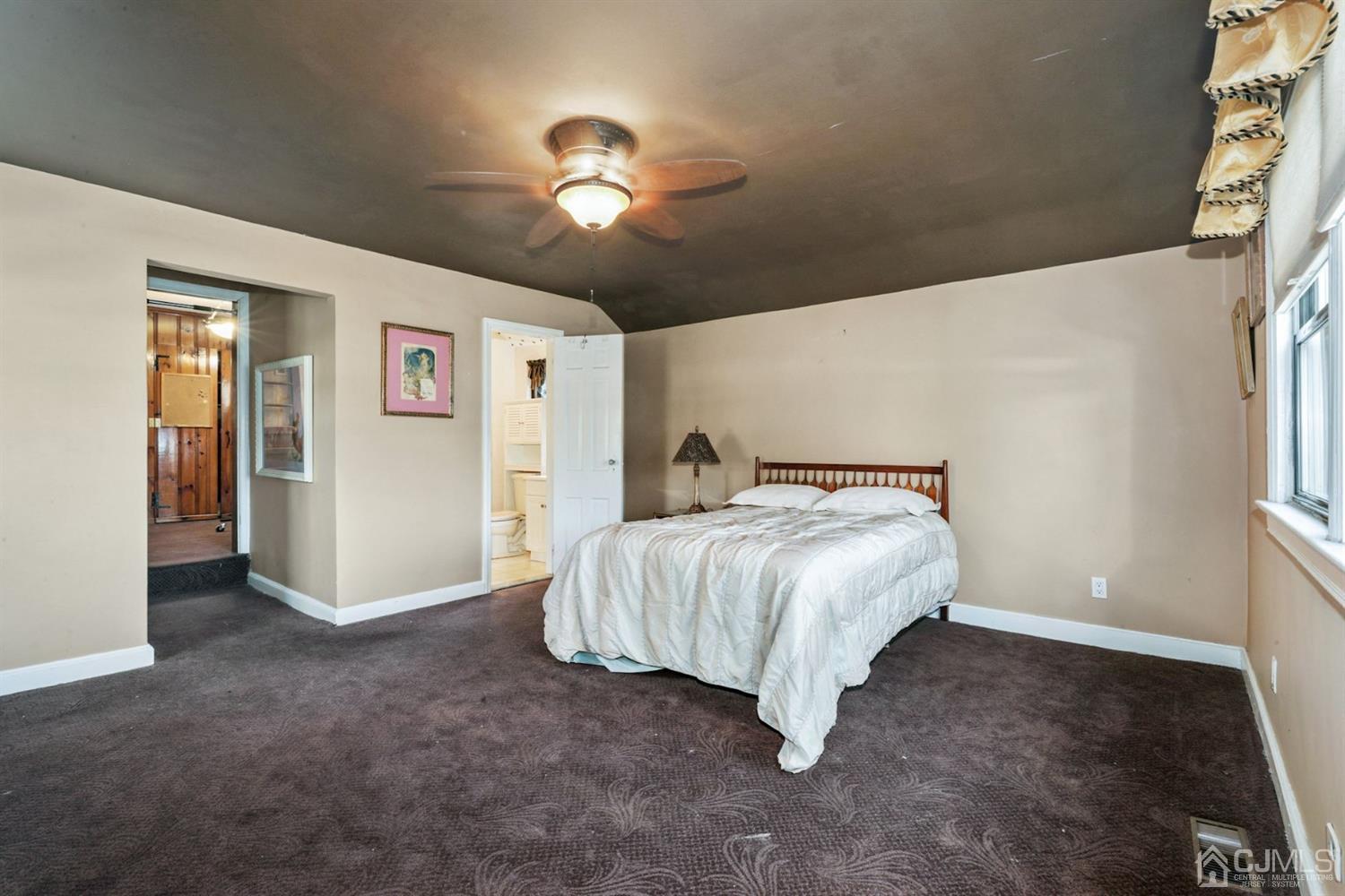 424 Chain O' Hills Road Colonia, NJ 07067 - Photo 12 of 36 a bed sitting in a room next to a window