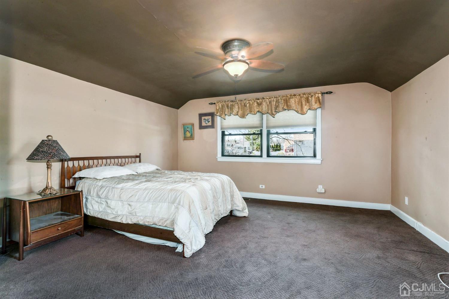 424 Chain O' Hills Road Colonia, NJ 07067 - Photo 13 of 36 a spacious bedroom with a bed and a window