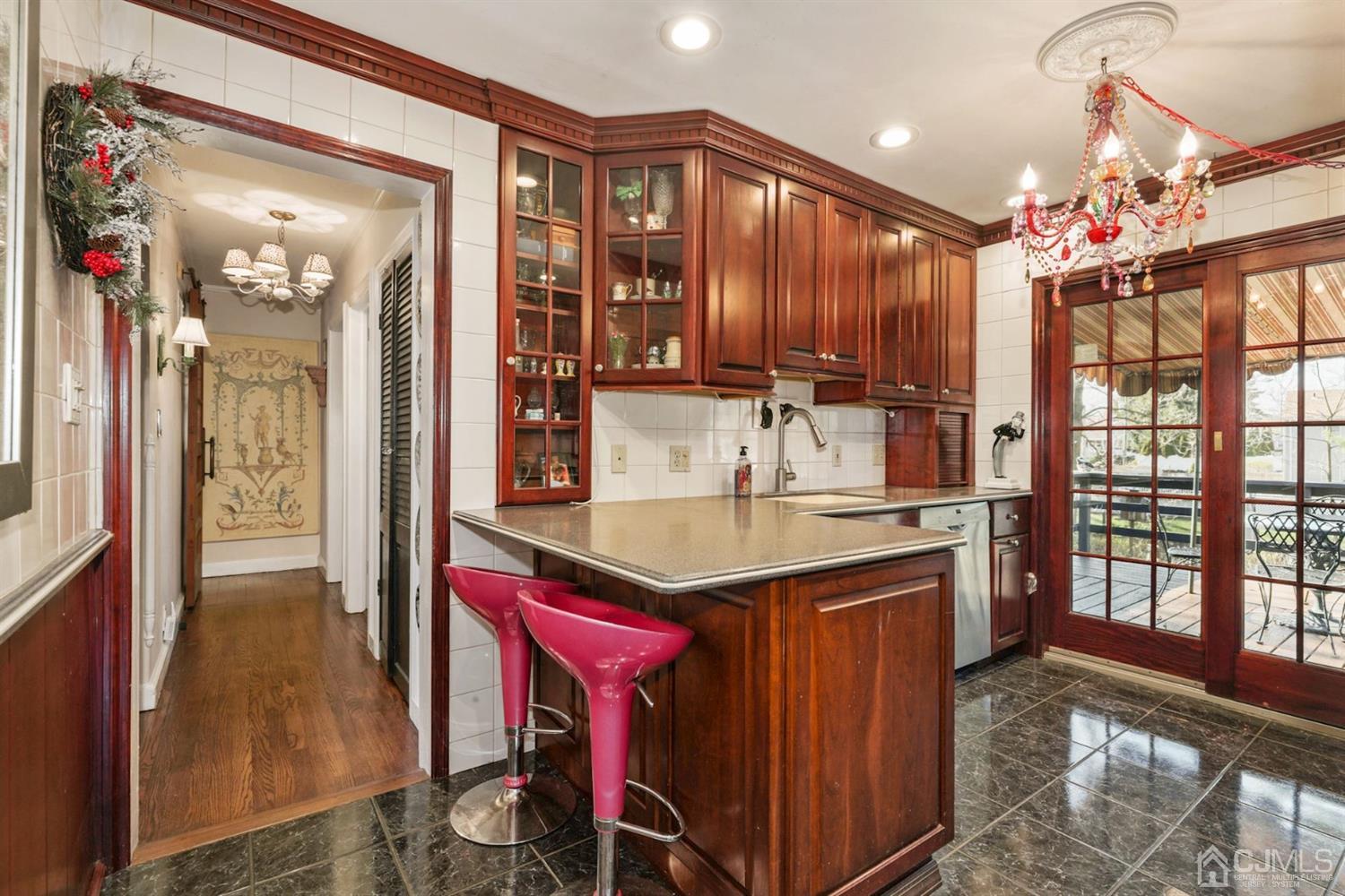 424 Chain O' Hills Road Colonia, NJ 07067 - Photo 19 of 36 a kitchen with a sink a stove cabinets and a dining table
